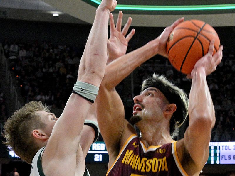 Jan 28, 2025; East Lansing, Michigan, USA;  Minnesota Golden Gophers forward Dawson Garcia (3) lis defended by Michigan State Spartans forward Jaxon Kohler (0) during the first half at Jack Breslin Student Events Center. Mandatory Credit: Dale Young-Imagn Images