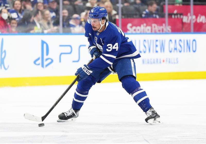 Dec 6, 2024; Toronto, Ontario, CAN; Toronto Maple Leafs center Auston Matthews (34) skates with the puck against the Washington Capitals during the first period at Scotiabank Arena. Mandatory Credit: Nick Turchiaro-Imagn Images