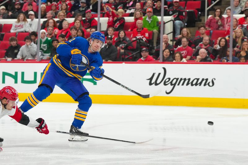 Nov 8, 2025; Raleigh, North Carolina, USA;  Buffalo Sabres center Ryan McLeod (71) takes a shot against the Carolina Hurricanes during the first period at Lenovo Center. Mandatory Credit: James Guillory-Imagn Images