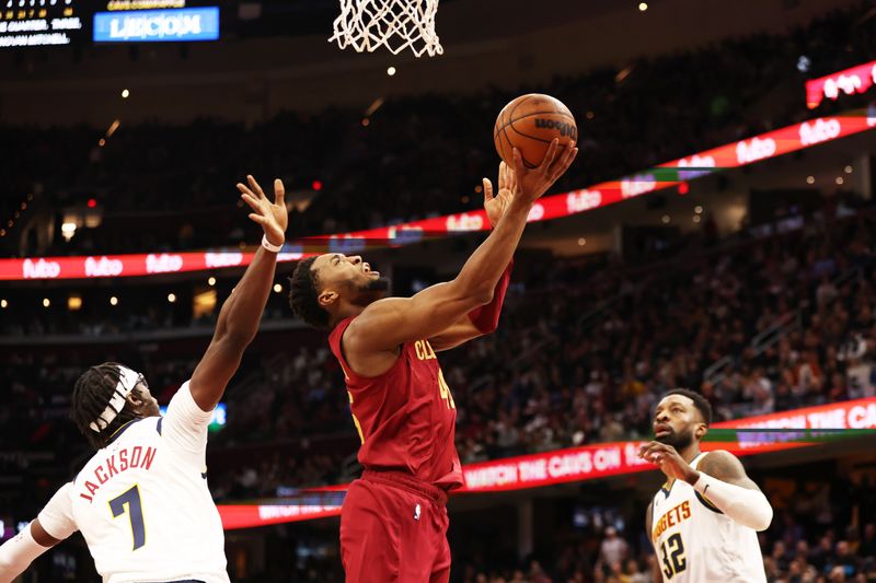 CLEVELAND, OH - FEBRUARY 23: Donovan Mitchell #45 of the Cleveland Cavaliers drives to the basket during the game against the Denver Nuggets on February 23, 2023 at Rocket Mortgage FieldHouse in Cleveland, Ohio. NOTE TO USER: User expressly acknowledges and agrees that, by downloading and/or using this Photograph, user is consenting to the terms and conditions of the Getty Images License Agreement. Mandatory Copyright Notice: Copyright 2022 NBAE (Photo by  Lauren Bacho/NBAE via Getty Images)