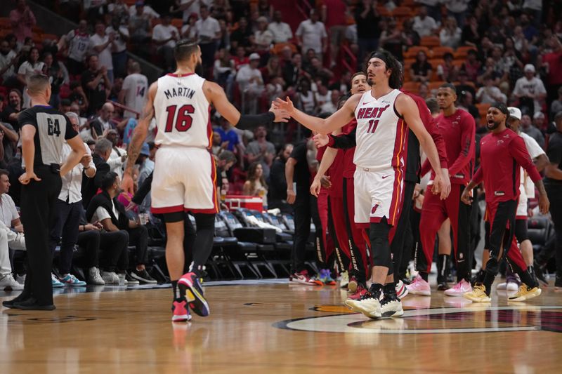 MIAMI, FL - APRIL 19: Jaime Jaquez Jr. #11 of the Miami Heat high fives Caleb Martin #16 during the game against the Chicago Bulls during the 2024 SoFi Play-In Tournament on April 19, 2024 at Kaseya Center in Miami, Florida. NOTE TO USER: User expressly acknowledges and agrees that, by downloading and or using this Photograph, user is consenting to the terms and conditions of the Getty Images License Agreement. Mandatory Copyright Notice: Copyright 2024 NBAE (Photo by Eric Espada/NBAE via Getty Images)