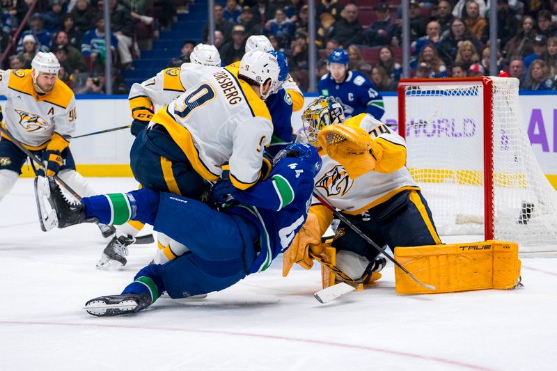 Nov 17, 2024; Vancouver, British Columbia, CAN; Nashville Predators goalie Juuse Saros (74) watches as forward Filip Forsberg (9) checks Vancouver Canucks forward Kiefer Sherwood (44) during the third period at Rogers Arena. Mandatory Credit: Bob Frid-Imagn Images