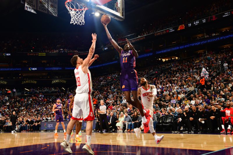 PHOENIX, AZ - FEBRUARY 29: Bol Bol #11 of the Phoenix Suns drives to the basket during the game against the Houston Rockets on February 29, 2023 at Footprint Center in Phoenix, Arizona. NOTE TO USER: User expressly acknowledges and agrees that, by downloading and or using this photograph, user is consenting to the terms and conditions of the Getty Images License Agreement. Mandatory Copyright Notice: Copyright 2023 NBAE (Photo by Kate Frese/NBAE via Getty Images)