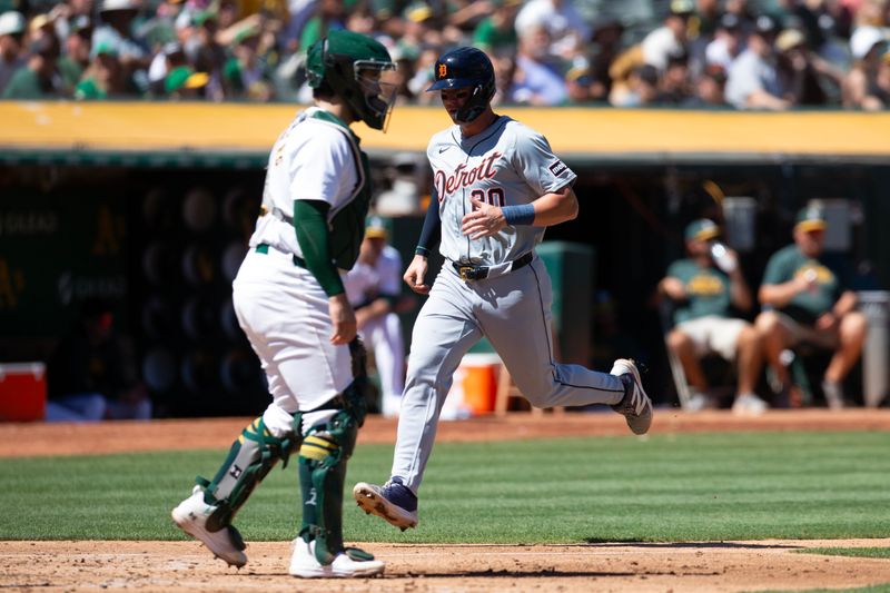 Sep 8, 2024; Oakland, California, USA; Detroit Tigers first baseman Spencer Torkelson (20) scores on a double by Trey Sweeney as Oakland Athletics catcher Shea Langeliers (23) waits on a late relay during the fourth inning at Oakland-Alameda County Coliseum. Mandatory Credit: D. Ross Cameron-Imagn Images