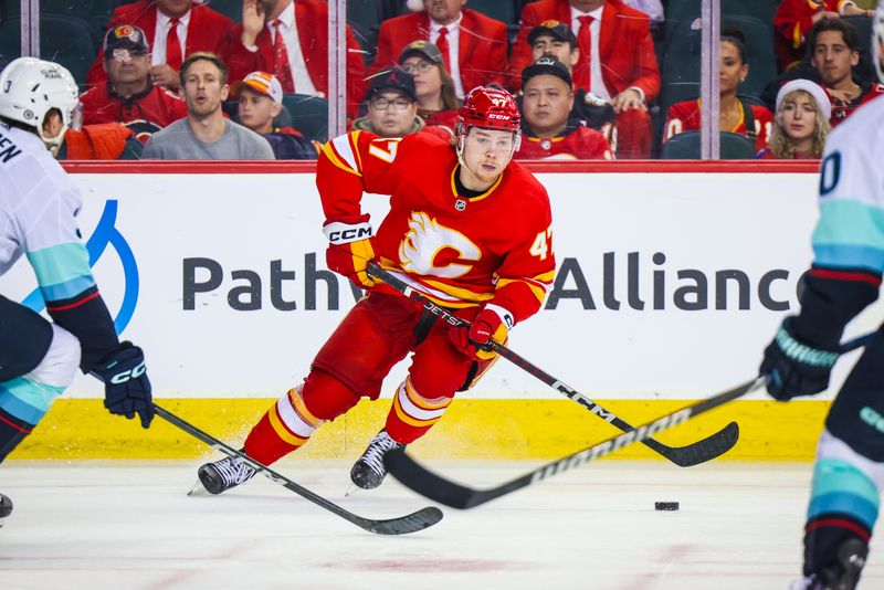 Dec 27, 2023; Calgary, Alberta, CAN; Calgary Flames center Connor Zary (47) controls the puck against the Seattle Kraken during the second period at Scotiabank Saddledome. Mandatory Credit: Sergei Belski-USA TODAY Sports