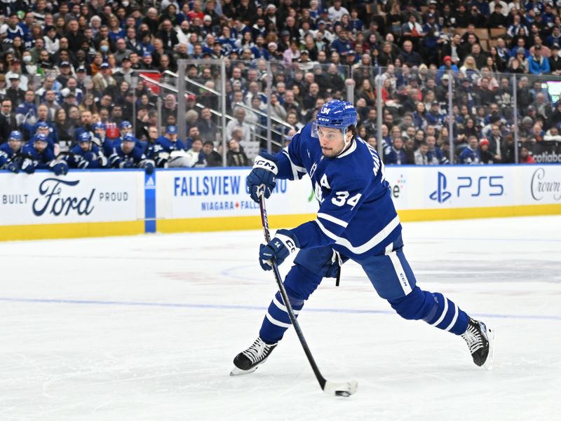 Jan 3, 2023; Toronto, Ontario, CAN; Toronto Maple Leafs forward Auston Matthews (34) shoots the puck against the St. Louis Blues in the first period at Scotiabank Arena. Mandatory Credit: Dan Hamilton-USA TODAY Sports