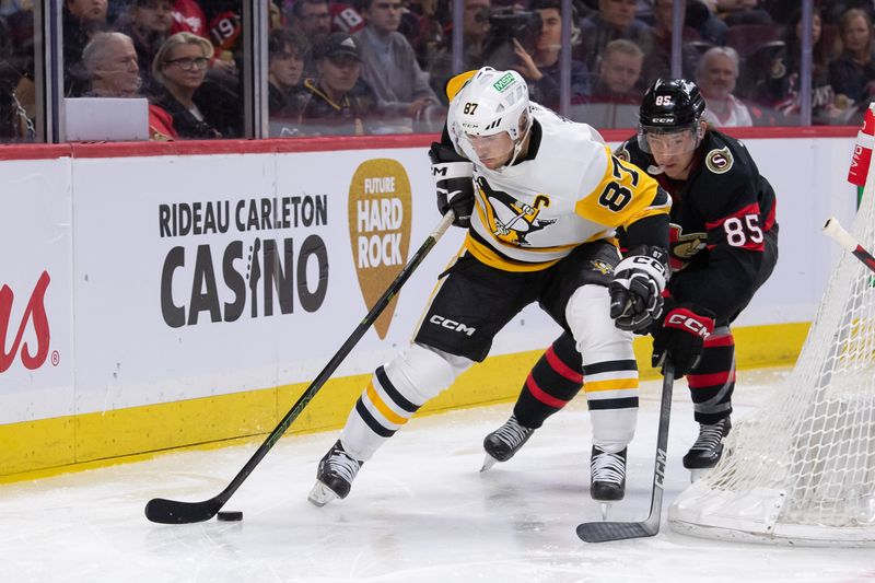 Mar 12, 2024; Ottawa, Ontario, CAN; Pittsburgh Penguins center Sidney Crosby (87) skates with the puck in front of Ottawa Senators defnseman Jake Sanderson (85) in the second period at the Canadian Tire Centre. Mandatory Credit: Marc DesRosiers-USA TODAY Sports