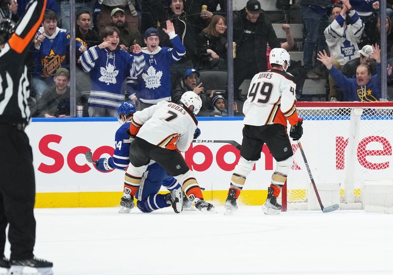 Feb 17, 2024; Toronto, Ontario, CAN; Anaheim Ducks defenseman Radko Gudas (7) cross checks Toronto Maple Leafs center Bobby McMann (74) during the second period at Scotiabank Arena. Mandatory Credit: Nick Turchiaro-USA TODAY Sports