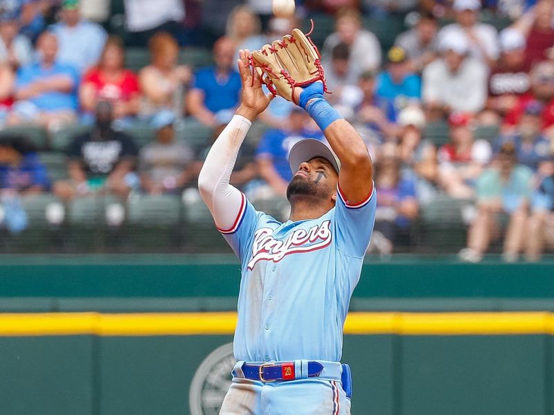 May 21, 2023; Arlington, Texas, USA; Texas Rangers shortstop Ezequiel Duran (20) catches a fly ball during the third inning against the Colorado Rockies at Globe Life Field. Mandatory Credit: Andrew Dieb-USA TODAY Sports