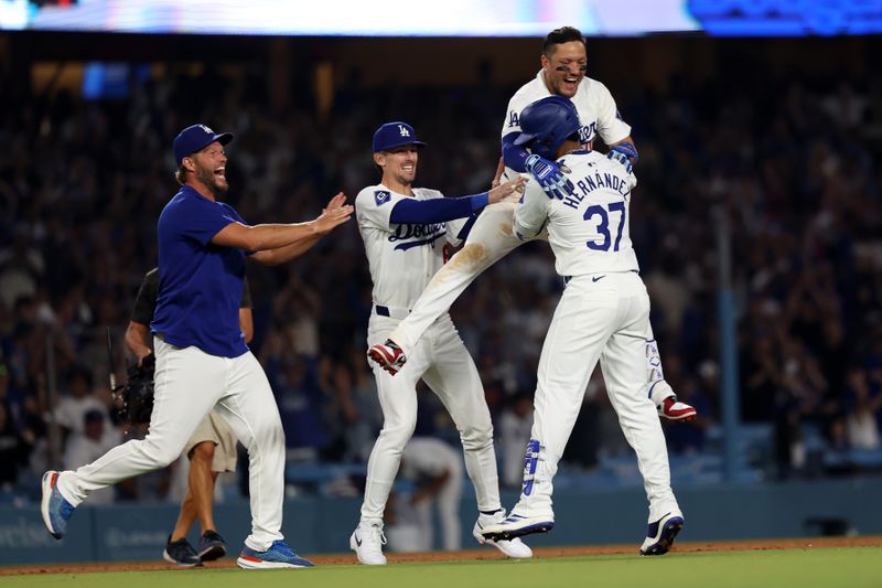 Jul 2, 2024; Los Angeles, California, USA;  Los Angeles Dodgers left fielder Teoscar Hernandez (37) celebrates with pitcher Clayton Kershaw (L) and second baseman Cavan Biggio (C) and shortstop Miguel Rojas (11) after hitting a walk off hit to defeat the Arizona Diamondbacks in bottom of the ninth inning at Dodger Stadium. Mandatory Credit: Kiyoshi Mio-USA TODAY Sports