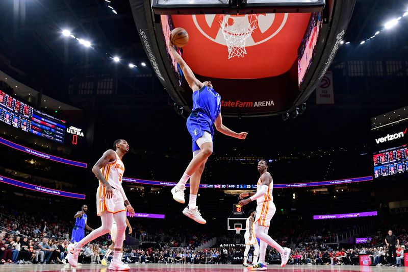 ATLANTA, GA - JANUARY 26: Dante Exum #0 of the Dallas Mavericks dunks the ball during the game against the Atlanta Hawks on January 26, 2024 at State Farm Arena in Atlanta, Georgia.  NOTE TO USER: User expressly acknowledges and agrees that, by downloading and/or using this Photograph, user is consenting to the terms and conditions of the Getty Images License Agreement. Mandatory Copyright Notice: Copyright 2024 NBAE (Photo by Adam Hagy/NBAE via Getty Images)