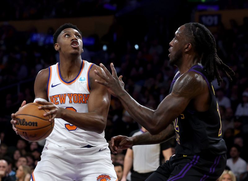 LOS ANGELES, CALIFORNIA - DECEMBER 18: RJ Barrett #9 of the New York Knicks looks to shoot in front of Taurean Prince #12 of the Los Angeles Lakersduring the first half at Crypto.com Arena on December 18, 2023 in Los Angeles, California. NOTE TO USER: User expressly acknowledges and agrees that, by downloading and or using this photograph, User is consenting to the terms and conditions of the Getty Images License Agreement. (Photo by Harry How/Getty Images)