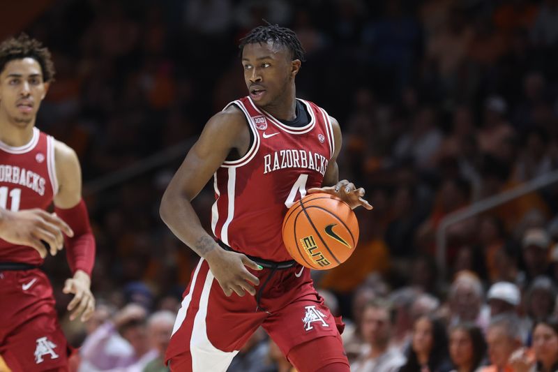 Feb 28, 2023; Knoxville, Tennessee, USA; Arkansas Razorbacks guard Davonte Davis (4) brings the ball up court against the Tennessee Volunteers during the first half at Thompson-Boling Arena. Mandatory Credit: Randy Sartin-USA TODAY Sports