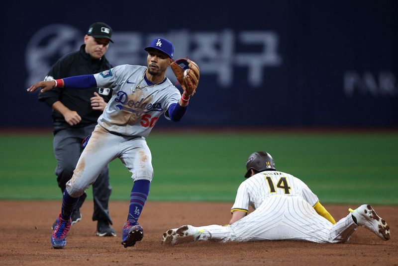 [US, Mexico & Canada customers only] March 20, 2024; Seoul, SOUTH KOREA; Los Angeles Dodgers infielder Mookie Betts catches the ball as San Diego Padres player Tyler Wade slides into second base during a MLB regular season Seoul Series game at Gocheok Sky Dome. Mandatory Credit: Kim Hong-Ji/Reuters via USA TODAY Sports