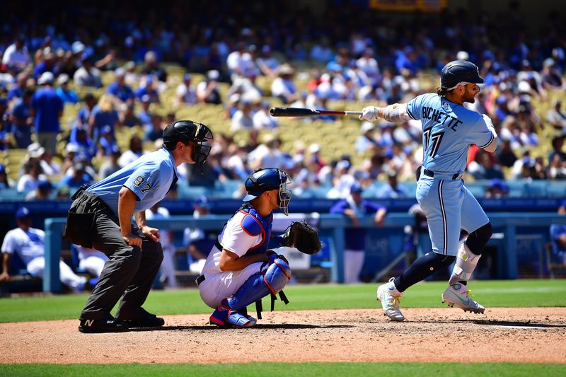 Jul 26, 2023; Los Angeles, California, USA; Toronto Blue Jays shortstop Bo Bichette (11) hits a single against the Los Angeles Dodgers during the fifth inning at Dodger Stadium. Mandatory Credit: Gary A. Vasquez-USA TODAY Sports