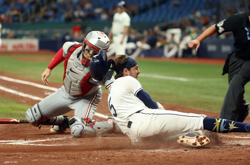 Sep 3, 2024; St. Petersburg, Florida, USA;  Minnesota Twins catcher Ryan Jeffers (27) tags out Tampa Bay Rays outfielder Josh Lowe (15) as he slides into home plate during the third inning at Tropicana Field. Mandatory Credit: Kim Klement Neitzel-Imagn Images