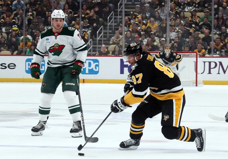 Oct 29, 2024; Pittsburgh, Pennsylvania, USA;  Pittsburgh Penguins center Sidney Crosby (87) moves the puck against the Minnesota Wild during the first period at PPG Paints Arena. Mandatory Credit: Charles LeClaire-Imagn Images