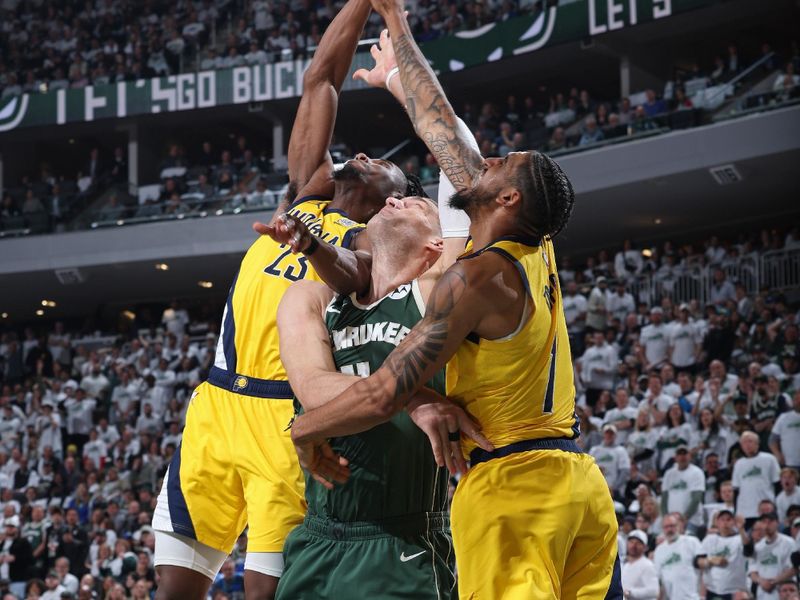 MILWAUKEE, WI - APRIL 23: Aaron Nesmith #23 of the Indiana Pacers rebounds during Round 1 Game 2 of the 2024 NBA Playoffs against the Milwaukee Bucks on April 23, 2024 at the Fiserv Forum Center in Milwaukee, Wisconsin. NOTE TO USER: User expressly acknowledges and agrees that, by downloading and or using this Photograph, user is consenting to the terms and conditions of the Getty Images License Agreement. Mandatory Copyright Notice: Copyright 2024 NBAE (Photo by Jeff Haynes/NBAE via Getty Images).