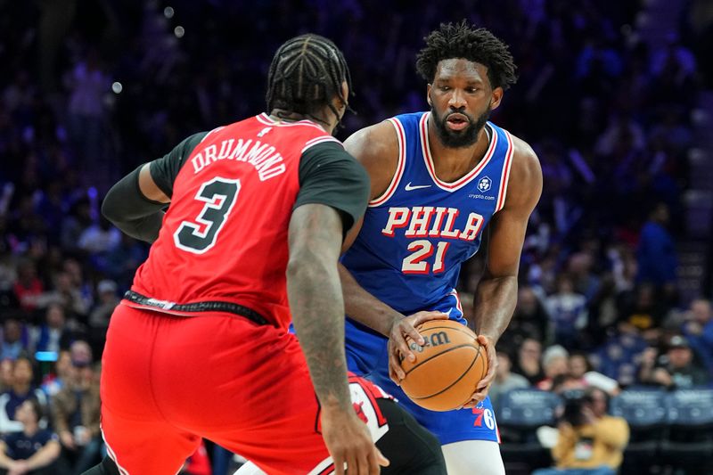 PHILADELPHIA, PENNSYLVANIA - JANUARY 2: Joel Embiid #21 of the Philadelphia 76ers controls the ball against Andre Drummond #3 of the Chicago Bulls at the Wells Fargo Center on January 2, 2024 in Philadelphia, Pennsylvania. The 76ers defeated the Bulls 110-97. NOTE TO USER: User expressly acknowledges and agrees that, by downloading and or using this photograph, User is consenting to the terms and conditions of the Getty Images License Agreement. (Photo by Mitchell Leff/Getty Images)