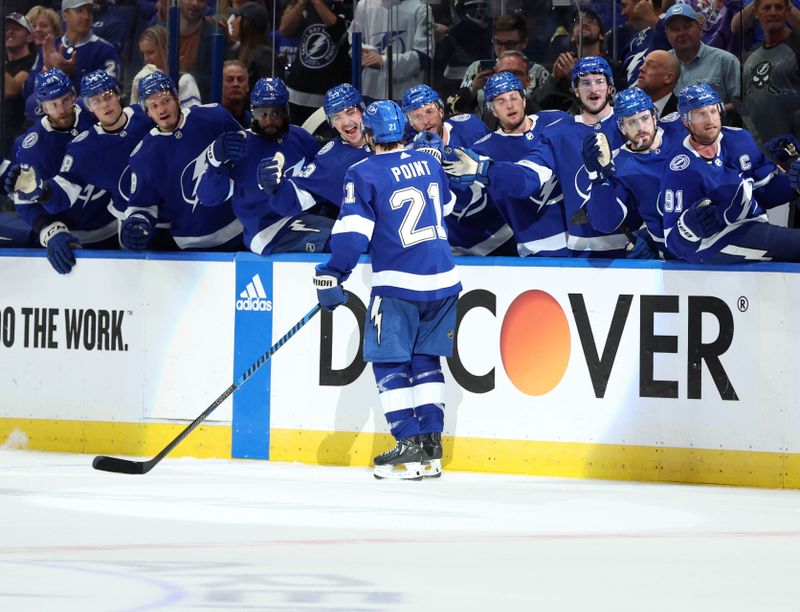 Apr 27, 2024; Tampa, Florida, USA; Tampa Bay Lightning center Brayden Point (21) celebrates with left wing Anthony Duclair (10) and teammates on the bench after he scored a goal against the Florida Panthers during the first period in game four of the first round of the 2024 Stanley Cup Playoffs at Amalie Arena. Mandatory Credit: Kim Klement Neitzel-USA TODAY Sports