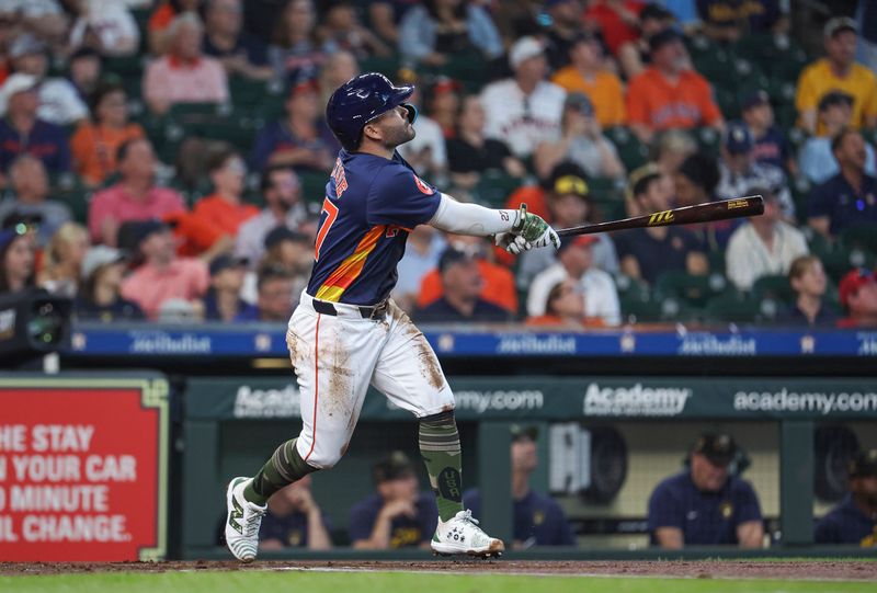 May 19, 2024; Houston, Texas, USA; Houston Astros second baseman Jose Altuve (27) hits a home run during the first inning against the Milwaukee Brewers at Minute Maid Park. Mandatory Credit: Troy Taormina-USA TODAY Sports