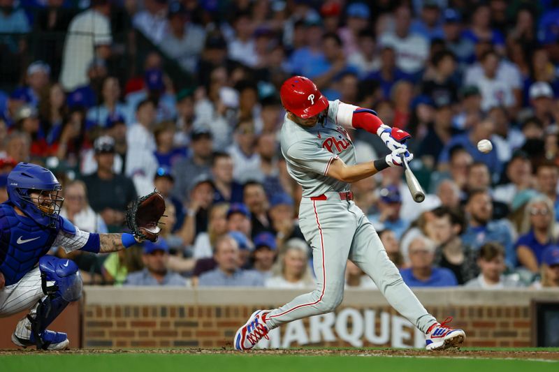 Jul 2, 2024; Chicago, Illinois, USA; Philadelphia Phillies shortstop Trea Turner (7) hits a two-run home run against the Chicago Cubs during the fifth inning at Wrigley Field. Mandatory Credit: Kamil Krzaczynski-USA TODAY Sports