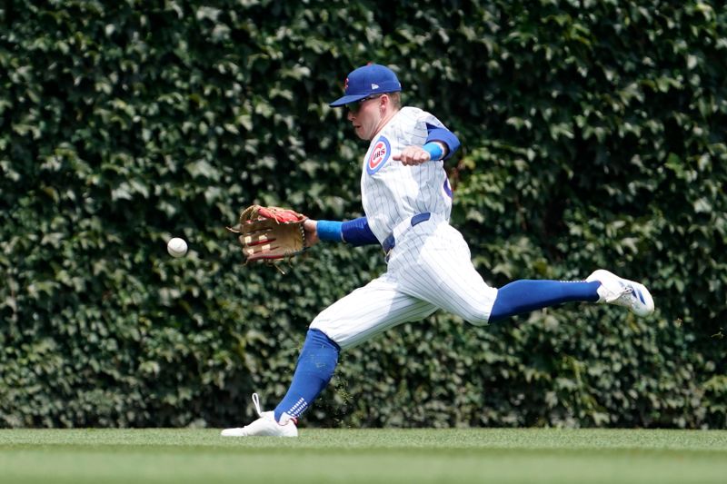 Jun 22, 2024; Chicago, Illinois, USA; Chicago Cubs outfielder Pete Crow-Armstrong (52) fields a single by New York Mets designated hitter J.D. Martinez (not pictured) during the first inning at Wrigley Field. Mandatory Credit: David Banks-USA TODAY Sports