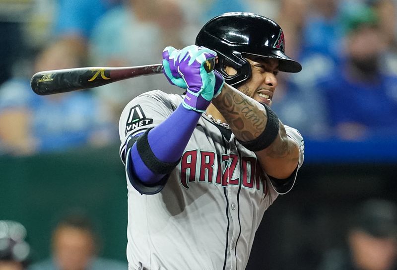 Jul 23, 2024; Kansas City, Missouri, USA; Arizona Diamondbacks second baseman Ketel Marte (4) hits a single during the eighth inning against the Kansas City Royals at Kauffman Stadium. Mandatory Credit: Jay Biggerstaff-USA TODAY Sports