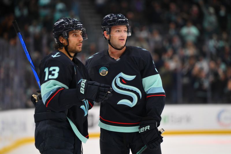 Oct 2, 2024; Seattle, Washington, USA; Seattle Kraken left wing Brandon Tanev (13) and defenseman Will Borgen (3) celebrate after Borgen scored a goal against the Edmonton Oilers during the third period at Climate Pledge Arena. Mandatory Credit: Steven Bisig-Imagn Images