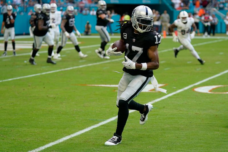 Las Vegas Raiders wide receiver Davante Adams runs for yardage during the second half of an NFL football game against the Miami Dolphins, Sunday, Nov. 19, 2023, in Miami Gardens, Fla. (AP Photo/Wilfredo Lee )