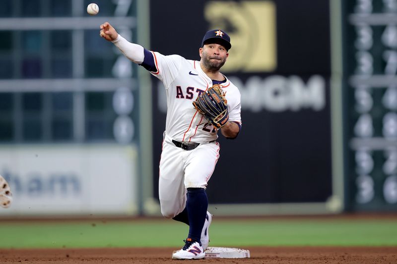 May 14, 2024; Houston, Texas, USA; Houston Astros second baseman Jose Altuve (27) throws a fielded ball to first base to complete a double play against the Oakland Athletics during the seventh inning at Minute Maid Park. Mandatory Credit: Erik Williams-USA TODAY Sports