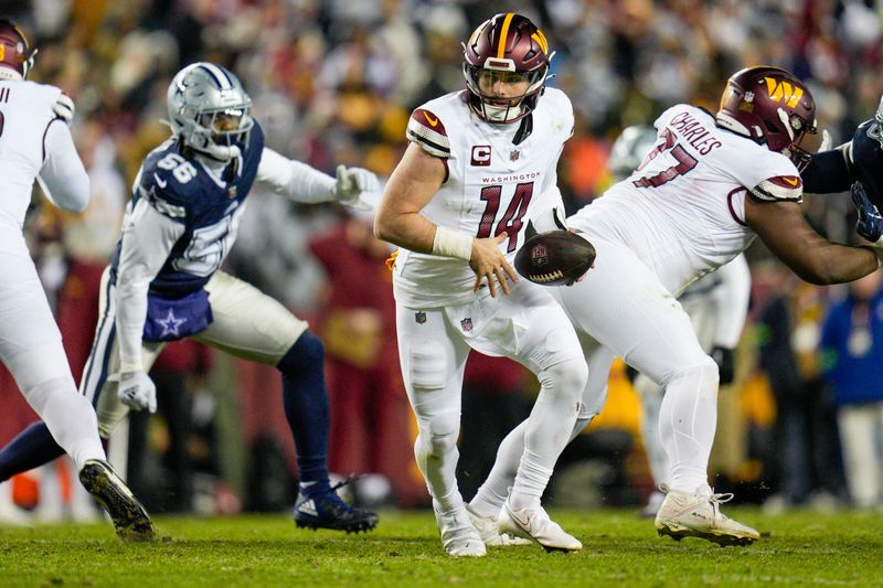 Washington Commanders quarterback Sam Howell (14) scrambles against the Dallas Cowboys during the first half, Sunday, January 7, 2024, in Landover, Md. Dallas won 38-10. (AP Photo/Jess Rapfogel)