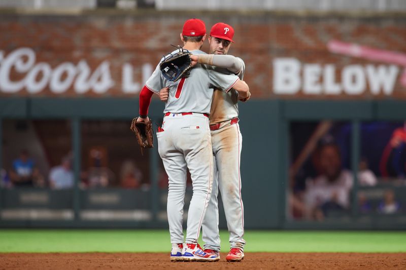 Jul 5, 2024; Atlanta, Georgia, USA; Philadelphia Phillies shortstop Trea Turner (7) and second baseman Whit Merrifield (9) celebrate after a victory against the Atlanta Braves at Truist Park. Mandatory Credit: Brett Davis-USA TODAY Sports