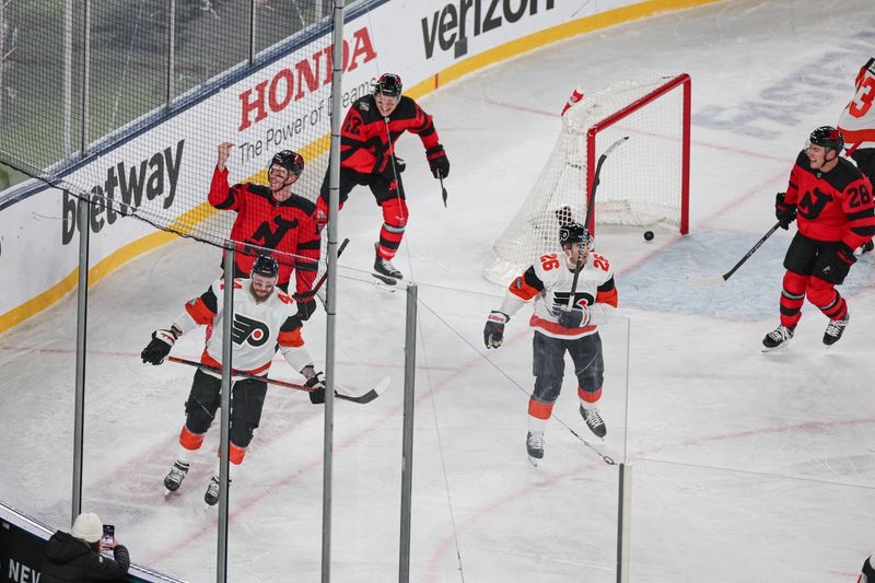 Feb 17, 2024; East Rutherford, New Jersey, USA; New Jersey Devils defenseman Brendan Smith (2) celebrates after scoring a goal past Philadelphia Flyers goaltender Samuel Ersson (33) in a Stadium Series ice hockey game at MetLife Stadium. Mandatory Credit: Vincent Carchietta-USA TODAY Sports