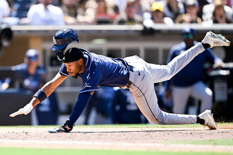 Apr 27, 2025; San Diego, California, USA; Tampa Bay Rays shortstop Chandler Simpson (14) dives to score on a wild pitch during the fifth inning against the San Diego Padres at Petco Park. Mandatory Credit: Denis Poroy-Imagn Images