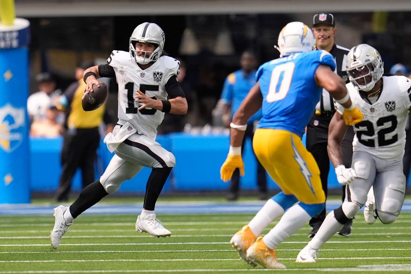 Las Vegas Raiders quarterback Gardner Minshew II (15) rolls out to pass against the Los Angeles Chargers during the second half of an NFL football game, Sunday, Sept. 8, 2024, in Inglewood, Calif. (AP Photo/Marcio Jose Sanchez)