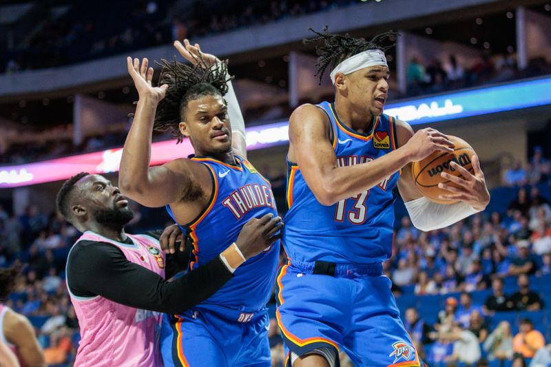 TULSA, OKLAHOMA - OCTOBER 10: Ousmane Dieng #13 of the Oklahoma City Thunder pulls down a rebound in the fourth quarter of a preseason game against the New Zealand Breakers at BOK Center on October 10, 2024 in Tulsa, Oklahoma.  NOTE TO USER: User expressly acknowledges and agrees that, by downloading and or using this photograph, User is consenting to the terms and conditions of the Getty Images License Agreement. (Photo by William Purnell/Getty Images)