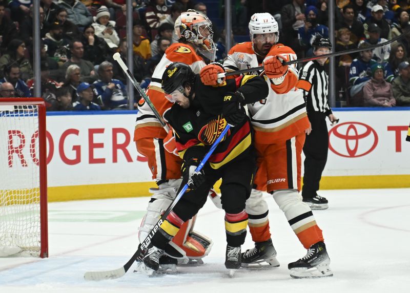 Mar 5, 2025; Vancouver, British Columbia, CAN Anaheim Ducks forward Alex Killorn (17) and goaltender John Gibson (36) checks Vancouver Canucks forward Conor Garland (8) during the first period   at Rogers Arena. Mandatory Credit: Simon Fearn-Imagn Images