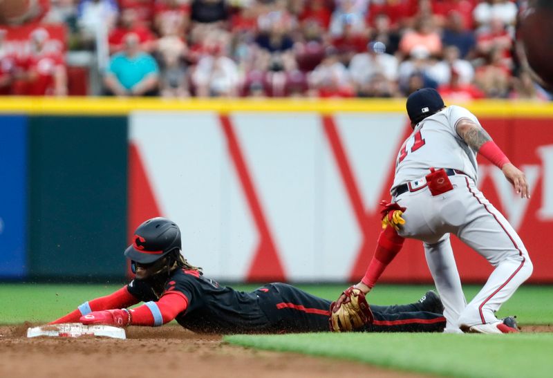 Jun 23, 2023; Cincinnati, Ohio, USA; Cincinnati Reds shortstop Elly De La Cruz (44) steals second base against Atlanta Braves shortstop Orlando Arcia (11) during the fifth inning at Great American Ball Park. Mandatory Credit: David Kohl-USA TODAY Sports