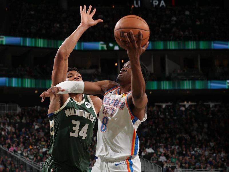 MILWAUKEE, WI - MARCH 24: Jalen Williams #8 of the Oklahoma City Thunder drives to the basket during the game against the Milwaukee Bucks on March 24, 2024 at the Fiserv Forum Center in Milwaukee, Wisconsin. NOTE TO USER: User expressly acknowledges and agrees that, by downloading and or using this Photograph, user is consenting to the terms and conditions of the Getty Images License Agreement. Mandatory Copyright Notice: Copyright 2024 NBAE (Photo by Gary Dineen/NBAE via Getty Images).