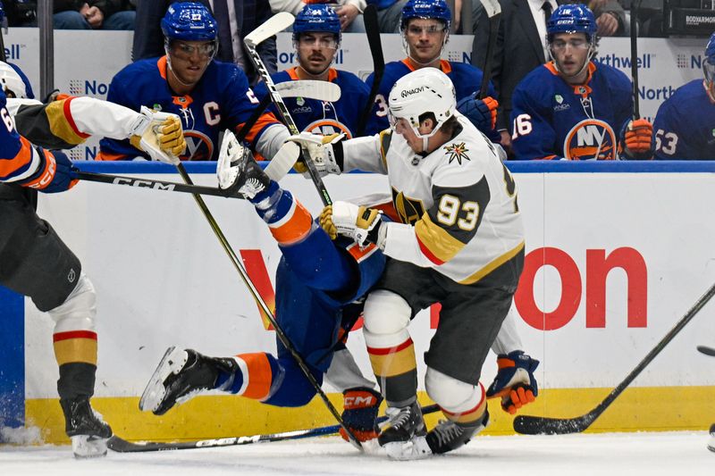 Dec 9, 2025; Elmont, New York, USA;  Vegas Golden Knights right wing Mitch Marner (93) checks New York Islanders defenseman Travis Mitchell (38) into the boards during the first period at UBS Arena. Mandatory Credit: Dennis Schneidler-Imagn Images