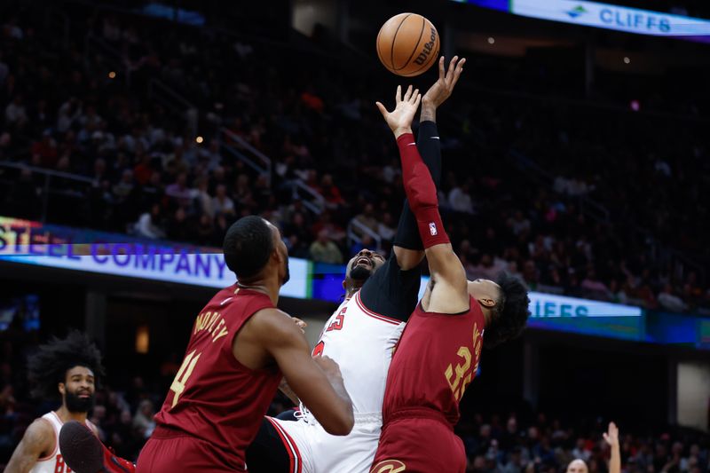 CLEVELAND, OH - FEBRUARY 14: Andre Drummond #3 of the Chicago Bulls rebounds against Evan Mobley #4 and Isaac Okoro #35 of the Cleveland Cavaliers during the second half at Rocket Mortgage Fieldhouse on February 14, 2024 in Cleveland, Ohio. NOTE TO USER: User expressly acknowledges and agrees that, by downloading and or using this photograph, User is consenting to the terms and conditions of the Getty Images License Agreement. (Photo by Ron Schwane/Getty Images)