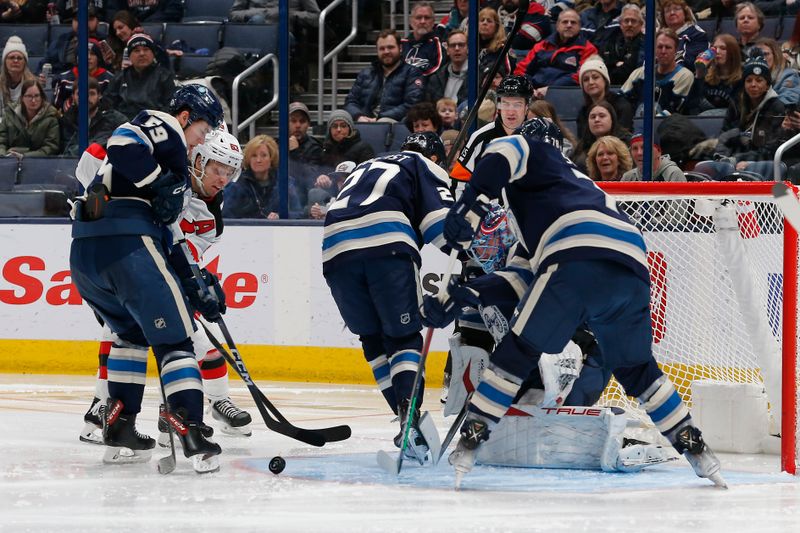 Jan 19, 2024; Columbus, Ohio, USA; Columbus Blue Jackets right wing Yegor Chinakhov (59) clears the round of a goalie Elvis Merzlikins (90) save against the New Jersey Devils during the second period at Nationwide Arena. Mandatory Credit: Russell LaBounty-USA TODAY Sports