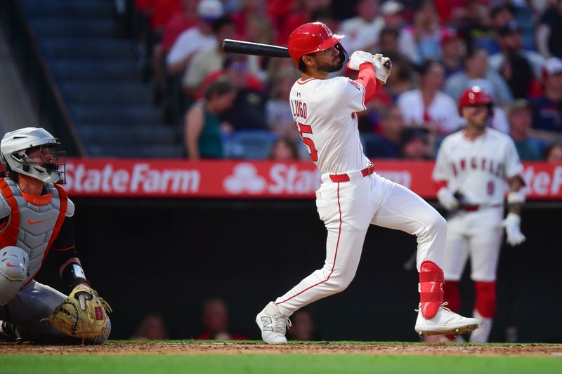 May 10, 2025; Anaheim, California, USA; Los Angeles Angels left fielder Matthew Lugo (15) hits an RBI triple for his first major league hit against the Baltimore Orioles during the fourth inning at Angel Stadium. Mandatory Credit: Gary A. Vasquez-Imagn Images