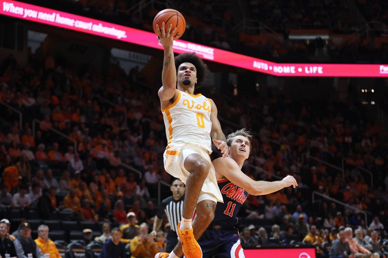 Feb 3, 2026; Knoxville, Tennessee, USA;  Mississippi Rebels forward Malik Dia (0) goes to the basket against Mississippi Rebels guard Travis Perry (11) during the first half at Thompson-Boling Arena at Food City Center. Mandatory Credit: Randy Sartin-Imagn Images