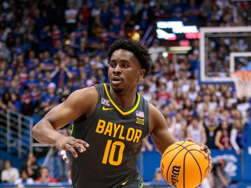 Feb 18, 2023; Lawrence, Kansas, USA; Baylor Bears guard Adam Flagler (10) drives to the basket during the first half against the Kansas Jayhawks at Allen Fieldhouse. Mandatory Credit: William Purnell-USA TODAY Sports