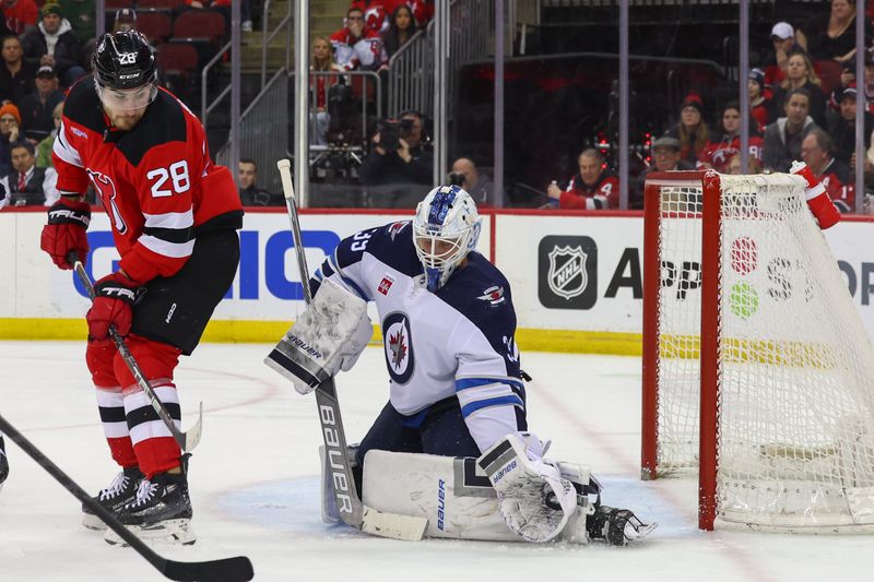 Mar 21, 2024; Newark, New Jersey, USA; Winnipeg Jets goaltender Laurent Brossoit (39) makes a save against the New Jersey Devils during the second period at Prudential Center. Mandatory Credit: Ed Mulholland-USA TODAY Sports