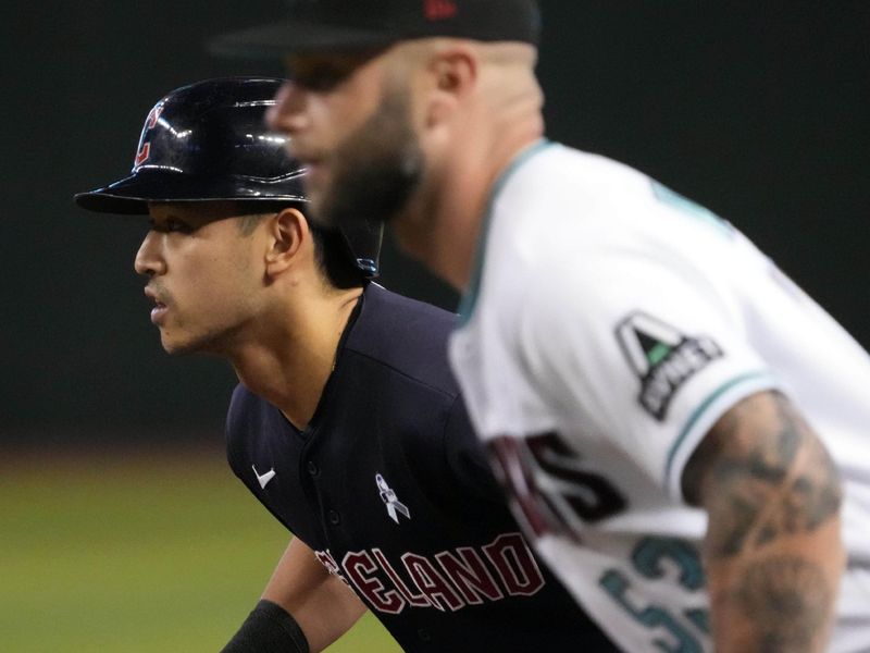 Jun 18, 2023; Phoenix, Arizona, USA; Cleveland Guardians left fielder Steven Kwan (38) leads off first base as Arizona Diamondbacks first baseman Christian Walker (53) covers the bag during the first inning at Chase Field. Mandatory Credit: Joe Camporeale-USA TODAY Sports