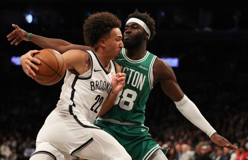 NEW YORK, NEW YORK - NOVEMBER 13: Jalen Wilson #22 of the Brooklyn Nets drives against Neemias Queta #88 of the Boston Celtics in the first quarter at Barclays Center on November 13, 2024 in New York City. NOTE TO USER: User expressly acknowledges and agrees that, by downloading and or using this photograph, User is consenting to the terms and conditions of the Getty Images License Agreement.  (Photo by Sarah Stier/Getty Images)