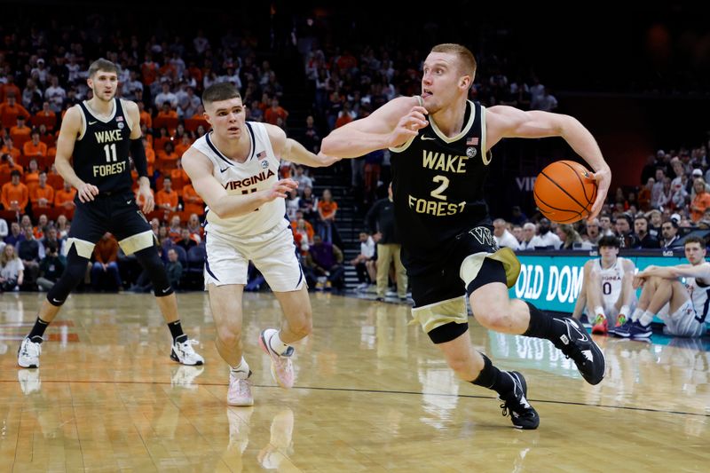 Feb 17, 2024; Charlottesville, Virginia, USA; Wake Forest Demon Deacons guard Cameron Hildreth (2) drives to the basket as Virginia Cavaliers guard Isaac McKneely (11) defends in the first half at John Paul Jones Arena. Mandatory Credit: Geoff Burke-USA TODAY Sports